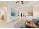 Spacious living area showing tile floors, a decorative entertainment center, and an open layout to the kitchen at 13215 Ramblewood Trl, Bradenton, FL 34211