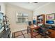 Functional home office space with multiple desks, built-in shelves, and a large window for natural light at 13215 Ramblewood Trl, Bradenton, FL 34211