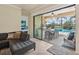 Covered patio with sliding doors, an outdoor kitchen, and a dining table overlooking the pool and backyard at 13215 Ramblewood Trl, Bradenton, FL 34211