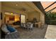 Covered patio with an outdoor kitchen, dining area, and seamless access to the living room, perfect for entertaining at 13215 Ramblewood Trl, Bradenton, FL 34211
