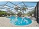 Enclosed pool and patio area, overlooking a serene lake view, perfect for outdoor relaxation and enjoyment at 13215 Ramblewood Trl, Bradenton, FL 34211