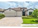 Charming single-story home boasts a tile roof, manicured landscaping, and a spacious two-car garage at 17723 Polo Trl, Bradenton, FL 34211