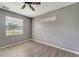 Bright bedroom with window, wood-look floors and ceiling fan at 1174 S Mcduff St, North Port, FL 34288