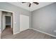 Bedroom with door to another room, gray walls and wood-look flooring at 1174 S Mcduff St, North Port, FL 34288