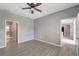 Simple bedroom with wood-look floors and access to bathroom at 1174 S Mcduff St, North Port, FL 34288