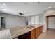 Open concept kitchen with granite island and wood cabinets at 1174 S Mcduff St, North Port, FL 34288