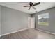 Spacious bedroom with window, wood-look floors and ceiling fan at 1174 S Mcduff St, North Port, FL 34288