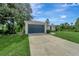 Single story home with a dark blue garage door at 1174 S Mcduff St, North Port, FL 34288