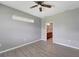 Bedroom with wood-look floors and access to bathroom at 1174 S Mcduff St, North Port, FL 34288