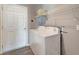 Bright laundry room with washer, dryer, and shelving at 1174 S Mcduff St, North Port, FL 34288