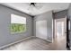 Simple bedroom with grey walls, wood-look flooring, and a double door closet at 1174 S Mcduff St, North Port, FL 34288