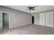 Spacious bedroom with wood-look floors and ceiling fan at 1174 S Mcduff St, North Port, FL 34288