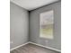 Bright bedroom with window blinds, gray walls, and wood-look flooring at 1174 S Mcduff St, North Port, FL 34288