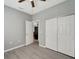 Bedroom with ceiling fan, double doors, and gray walls at 1174 S Mcduff St, North Port, FL 34288