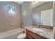 Bathroom with tub, granite countertop, and gray walls at 1174 S Mcduff St, North Port, FL 34288