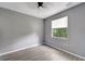Bedroom with window blinds, gray walls, and wood-look flooring at 1174 S Mcduff St, North Port, FL 34288