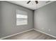 Bedroom with window blinds, gray walls, and wood-look flooring at 1174 S Mcduff St, North Port, FL 34288