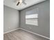 Bedroom with window blinds, gray walls, and wood-look flooring at 1174 S Mcduff St, North Port, FL 34288