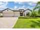 Two-story house with tile roof, two-car garage, and manicured lawn at 17723 Polo Trl, Bradenton, FL 34211