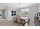 Bright dining room features a wood table with six chairs, chandelier, and stylish wall art at 17723 Polo Trl, Bradenton, FL 34211