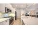 Modern kitchen with white cabinets, stainless steel appliances and large island at 7275 Lismore Ct, Lakewood Ranch, FL 34202