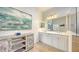 Double vanity bathroom with large shower and art at 7275 Lismore Ct, Lakewood Ranch, FL 34202