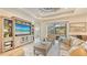 Relaxing living room, large TV, and pool access at 7275 Lismore Ct, Lakewood Ranch, FL 34202
