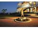 Grand clubhouse exterior at night with a golfer statue in front at 7275 Lismore Ct, Lakewood Ranch, FL 34202