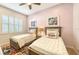 Twins bedroom with light pink walls, white shutters and flamingo artwork at 7275 Lismore Ct, Lakewood Ranch, FL 34202