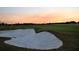 Sand trap on a beautifully manicured golf course at sunset at 7275 Lismore Ct, Lakewood Ranch, FL 34202