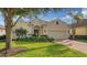 Tan single-story home with brick driveway and landscaping at 7275 Lismore Ct, Lakewood Ranch, FL 34202