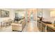Living room with comfortable seating and a view into the kitchen and entryway at 7275 Lismore Ct, Lakewood Ranch, FL 34202