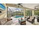 Screened-in patio with pool, seating, and grill at 7275 Lismore Ct, Lakewood Ranch, FL 34202