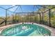 Relaxing kidney-shaped pool with screened enclosure at 7275 Lismore Ct, Lakewood Ranch, FL 34202