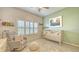 Bedroom with a crib, rocker, and calming decor at 7275 Lismore Ct, Lakewood Ranch, FL 34202