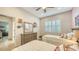 Shared bedroom with twin beds, dresser and access to another room at 7275 Lismore Ct, Lakewood Ranch, FL 34202