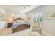 Large main bedroom with king-size bed and sitting area at 7275 Lismore Ct, Lakewood Ranch, FL 34202