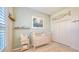 Bedroom with a crib, light-green walls, and beach decor at 7275 Lismore Ct, Lakewood Ranch, FL 34202