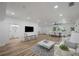 Open concept living area with hardwood floors and views into dining and kitchen areas at 353 Suwanee Ave, Sarasota, FL 34243