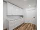 White cabinets and quartz countertops in this laundry room at 353 Suwanee Ave, Sarasota, FL 34243