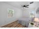 Bright bedroom with a queen bed and two windows at 353 Suwanee Ave, Sarasota, FL 34243