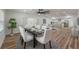Bright dining room features a modern table with white chairs and hardwood floors at 353 Suwanee Ave, Sarasota, FL 34243