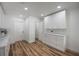 Bright laundry room with white cabinets and quartz countertops at 353 Suwanee Ave, Sarasota, FL 34243