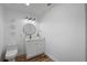 Bathroom with white vanity, round mirror, and modern fixtures at 353 Suwanee Ave, Sarasota, FL 34243