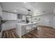 Modern kitchen with white cabinets, large island, and stainless steel appliances at 353 Suwanee Ave, Sarasota, FL 34243