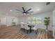 Modern farmhouse dining room with white chairs, hardwood floors, and a ceiling fan at 353 Suwanee Ave, Sarasota, FL 34243