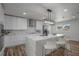 Modern kitchen with white cabinets, quartz countertops, and a large island at 353 Suwanee Ave, Sarasota, FL 34243