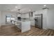 Modern kitchen with white cabinets, large island, and stainless steel appliances at 353 Suwanee Ave, Sarasota, FL 34243
