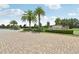 Gated community entrance with brick pavers and landscaping at 13215 Ramblewood Trl, Bradenton, FL 34211