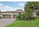 House with tile roof, two-car garage, and landscaped yard at 13215 Ramblewood Trl, Bradenton, FL 34211